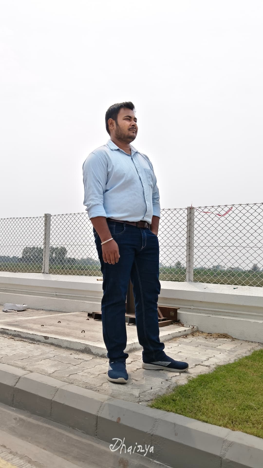 Dhairya Swaraj on a rooftop overlooking fields
